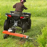 DR Tow-Behind Trimmer Mower attached to an ATV